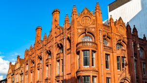 Thermal comfort simulation for heritage retrofit: red-brick Victorian Gothic community hall exterior with pointed-arch windows and gables