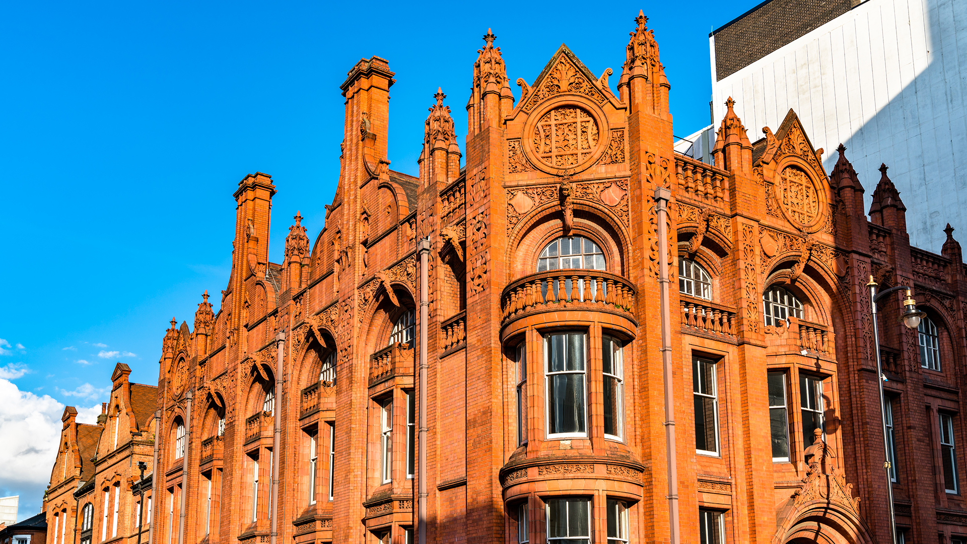 Thermal comfort simulation for heritage retrofit: red-brick Victorian Gothic community hall exterior with pointed-arch windows and gables